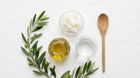 Coconut oil, olive oil and water, the basic ingredients of true soap, on a white surface