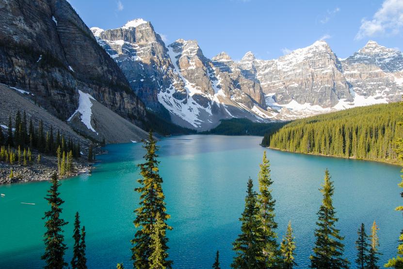 Mountain lake with clear blue water and snow-capped peaks