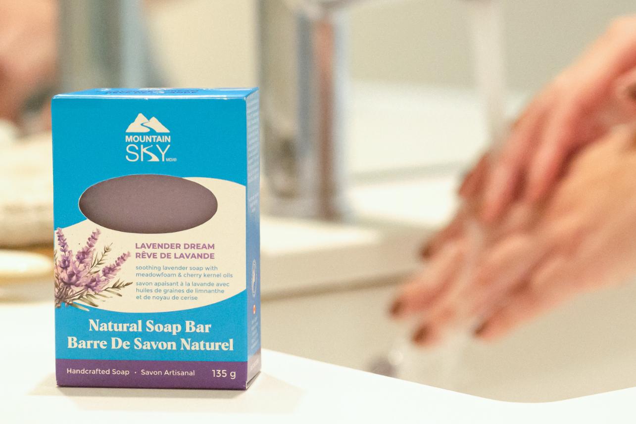 Mountain Sky Natural Soap Bar packaging on a bathroom counter with hands in the background