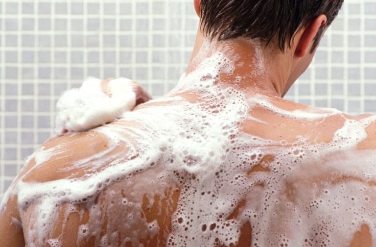 Person with soapy back in a shower setting